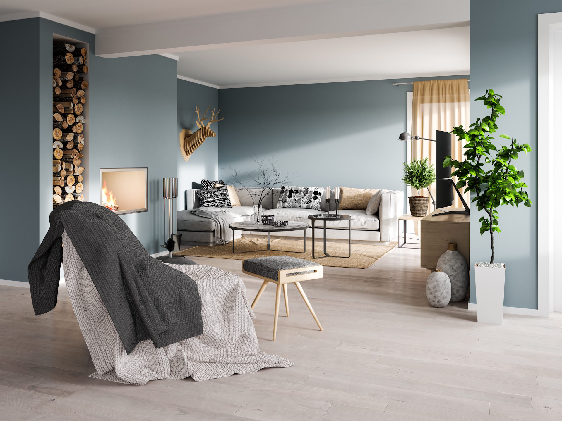 Entdecken Sie hochwertigen Laminatboden bei Ihrem Fachhandel in Gronau, der durch modernes Design und langlebige Qualität überzeugt. Unsere stilvollen Bodenbeläge verleihen jedem Wohnraum eine warme Atmosphäre und bilden die perfekte Grundlage für Ihr individuelles Einrichtungskonzept. | Bildbeschreibung Ein lichtdurchflutetes, modern eingerichtetes Wohnzimmer mit hellgrauem Laminatboden in Holzoptik. Im Vordergrund steht ein Sessel mit Deckenwurf, während im Hintergrund ein graues Ecksofa, ein flacher Couchtisch und ein moderner Kamin zu sehen sind. Die Wände sind in einem matten Blaugrau gehalten, ergänzt durch dekorative Elemente wie ein Hirschgeweih aus Holz, Zimmerpflanzen und ein gestapeltes Holzlager neben dem Kamin.