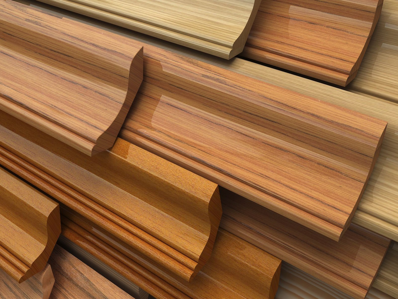 Verleihen Sie Ihrem Echtholzboden ein edles Finish mit exklusiven Parkett Sockelleisten direkt in Gronau. Unsere hochwertigen Leisten aus Echtholz oder furniertem Material garantieren einen nahtlosen Übergang und unterstreichen den natürlichen Charakter Ihres hochwertigen Parkettbodens.  Bildbeschreibung: Das Bild zeigt eine Auswahl verschiedener profilierter Sockelleisten aus Holz in unterschiedlichen Brauntönen und Maserungen. Die Leisten sind fächerartig übereinander gestapelt, wobei die glänzenden Oberflächen und die detaillierten Fräsungen der verschiedenen Holzarten wie Eiche, Buche oder Nussbaum deutlich sichtbar sind.